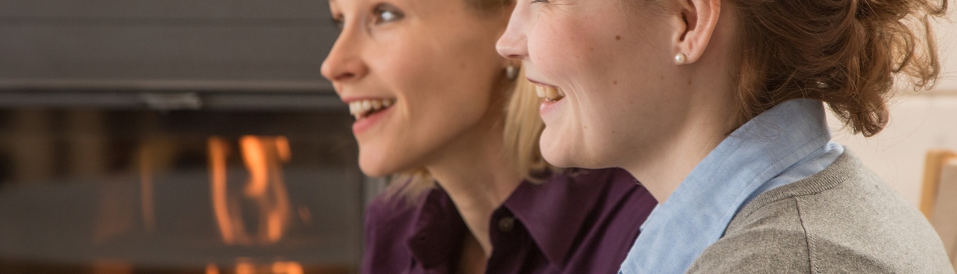 Two women listening and laughing